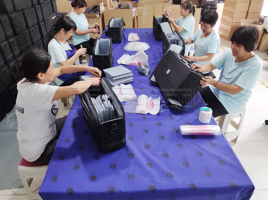 Workers inspecting custom bags before shipment